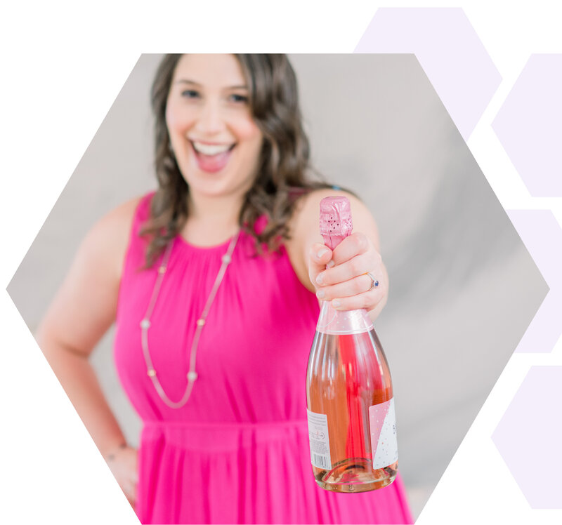Isabel Kateman holding out a bottle of champagne and celebrating a client website launch