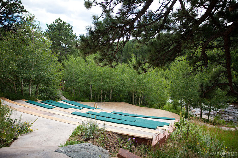 River Run Outdoor ceremony with stadium seating next to Saint Vrain River at Wild Basin Lodge in Allenspark Colorado