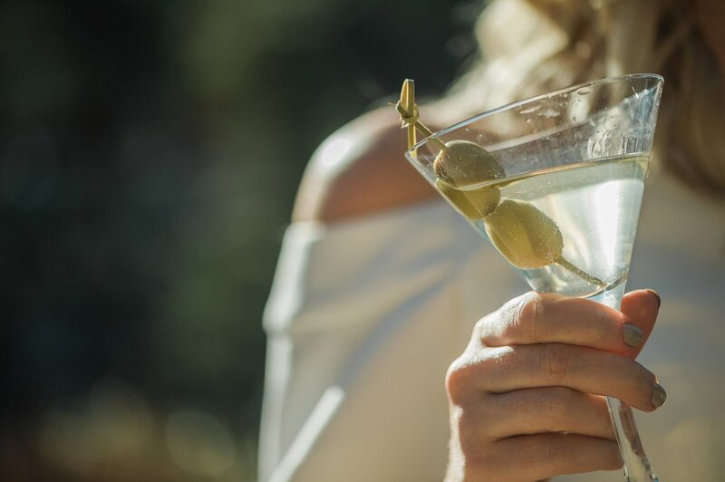 martini glass in ladies hands during cocktail party