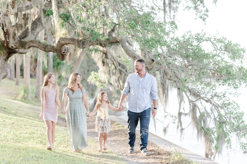 family walking near a hanging moss tree