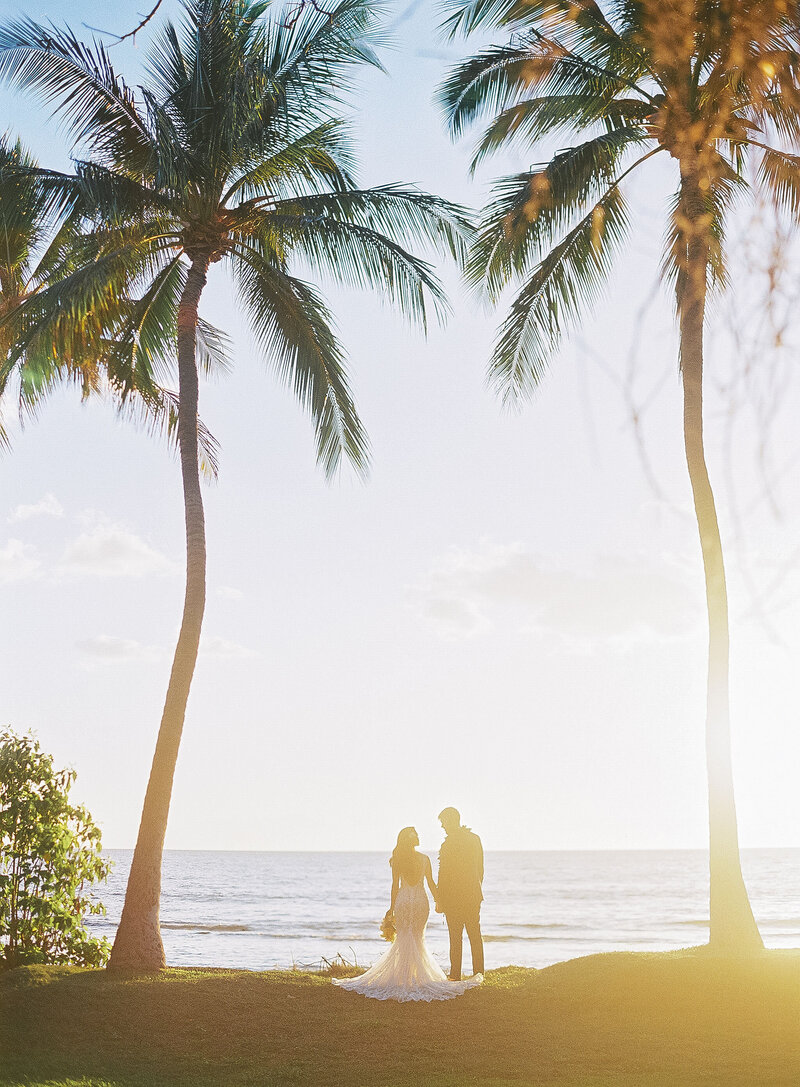 bride and groom by the ocean in Hawaii