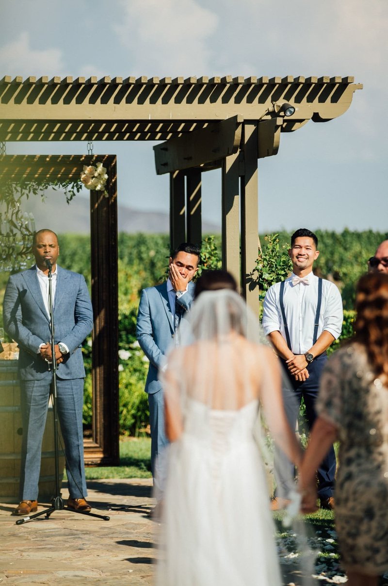 Groom catches his breath as his Bride approaches the altar