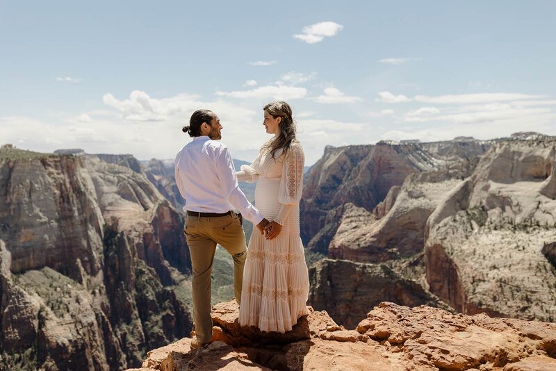 a couple standing at observation point during their elopement in Zion National Park