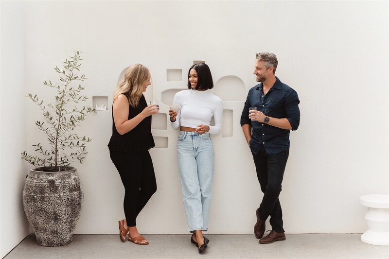 Three people standing having a conversation