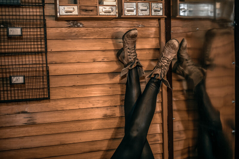 Hannah Ellaham Brand Expert's  combat boots and shiny black leggings sticking up in  air - photo by Ahnvee Photography