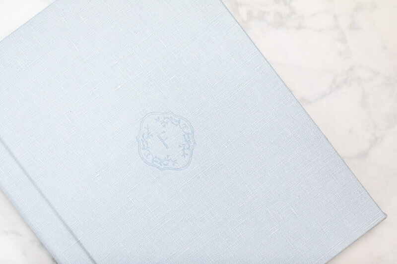 Light blue linen album with embossed letter