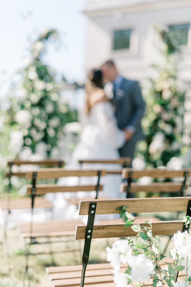 Chateau Des Fleurs Wedding ceremony outside with wooden chairs