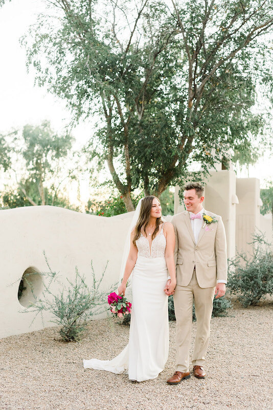 Married Couple holding hands outside of a desert gate