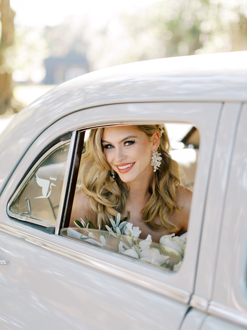 Augusta smiles at the camera at her Middleton Place Wedding in Charleston South Carolina, photo by Charleston Wedding Photographer Cynthia Mae Photography