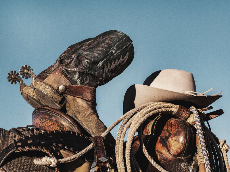 Cowboy Boots and Hat On A Saddle, From The Lore Of The Range Collection