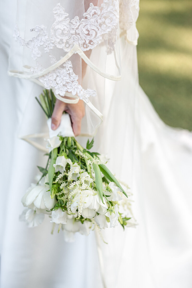 Photo of bride's bouquet in her hand at Napa wedding by Suzanne Karp Photography