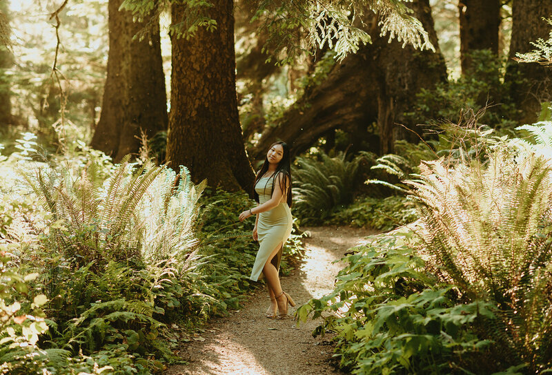 girl walking through the woods on a dirt path