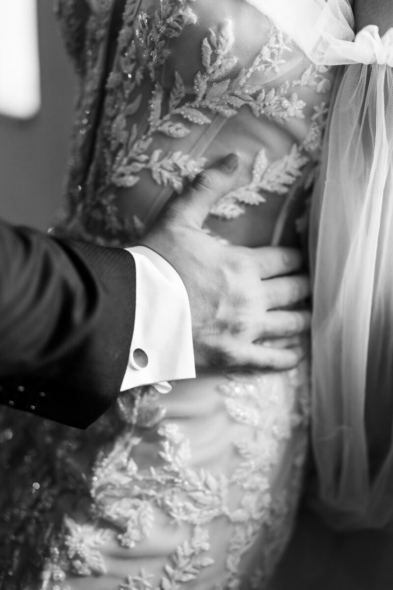 groom holding bride by the waist by Wedding photographer atlanta ga