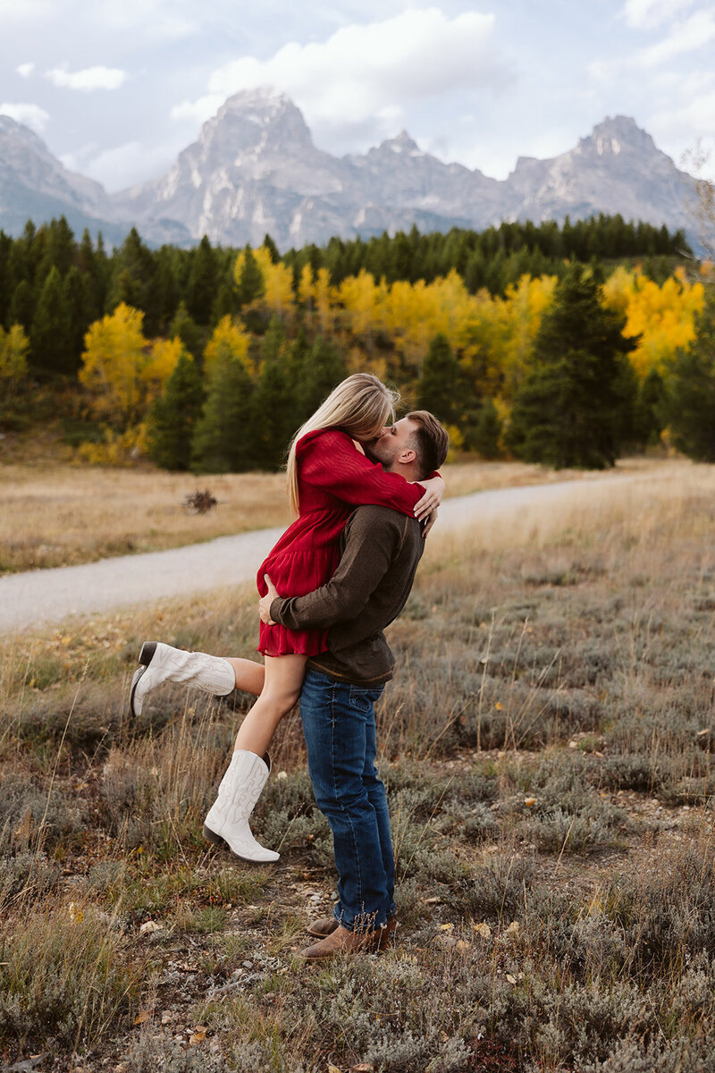 A couple looking into each others eyes laughing in the Sawtooth mountains in Stanley, Idaho