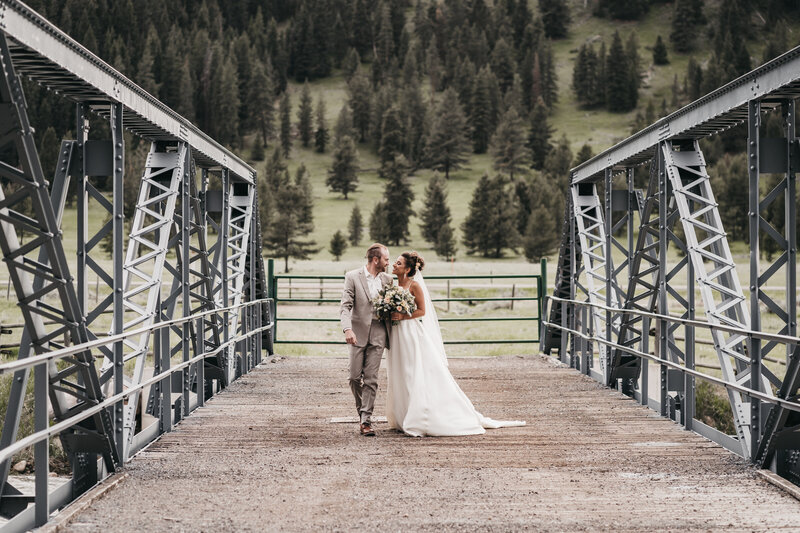 Husband and bride walking on a bridge during their elopement.
