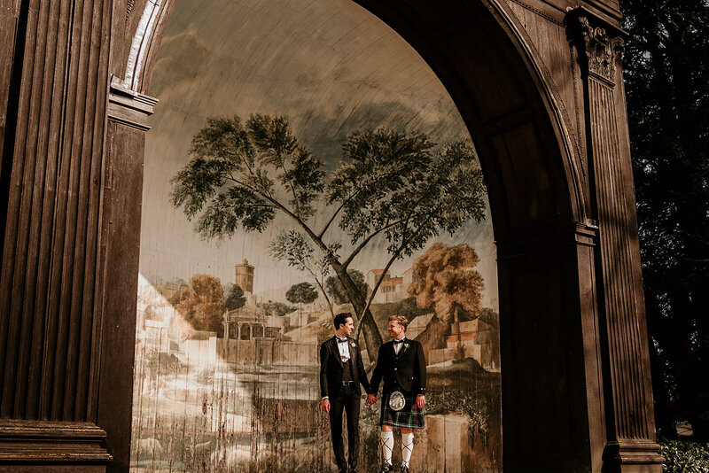 Grooms under historic arch