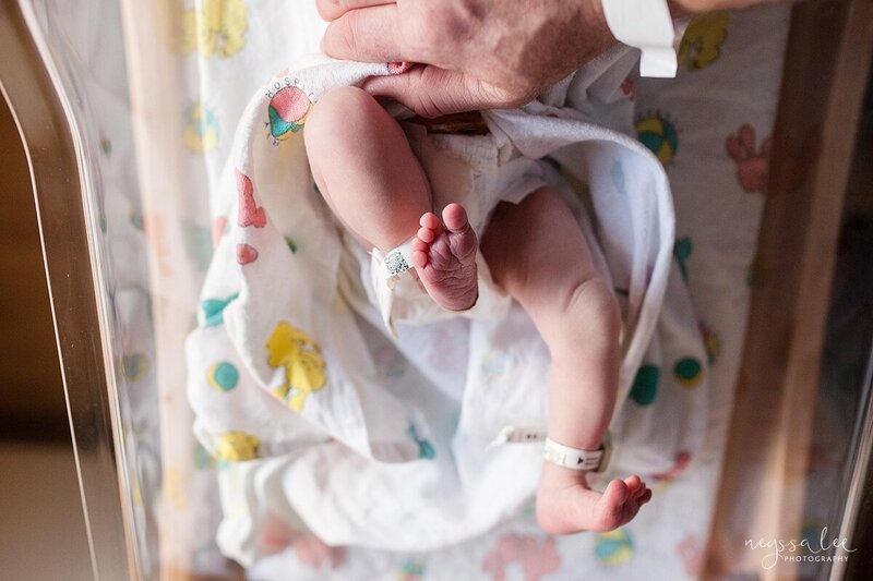 Photo of father holding newborn baby and giving kiss