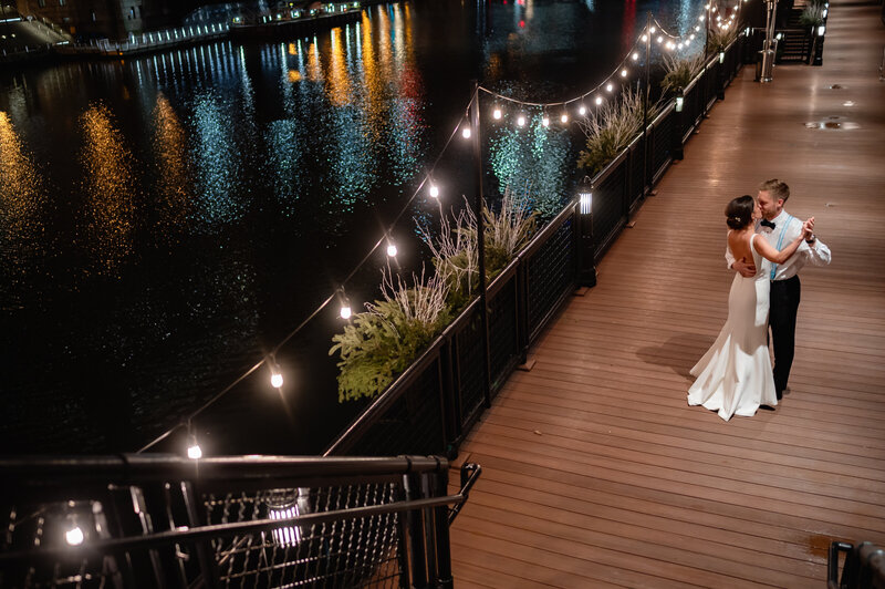 Bride and groom dance on the river walk at River Roast