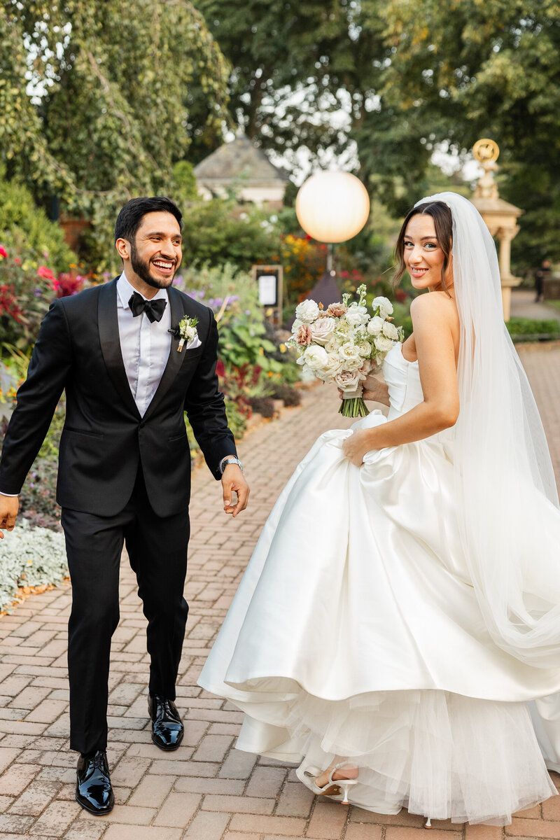 bride and groom walking toward wedding guests at wedding in chicago, Illinois