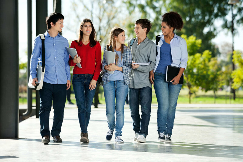 Diverse group of university students walking to class