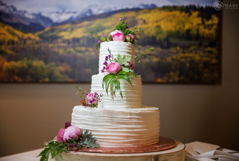 Pretty white wedding cake in private dining room at Aurum Food & Wine in Steamboat Springs