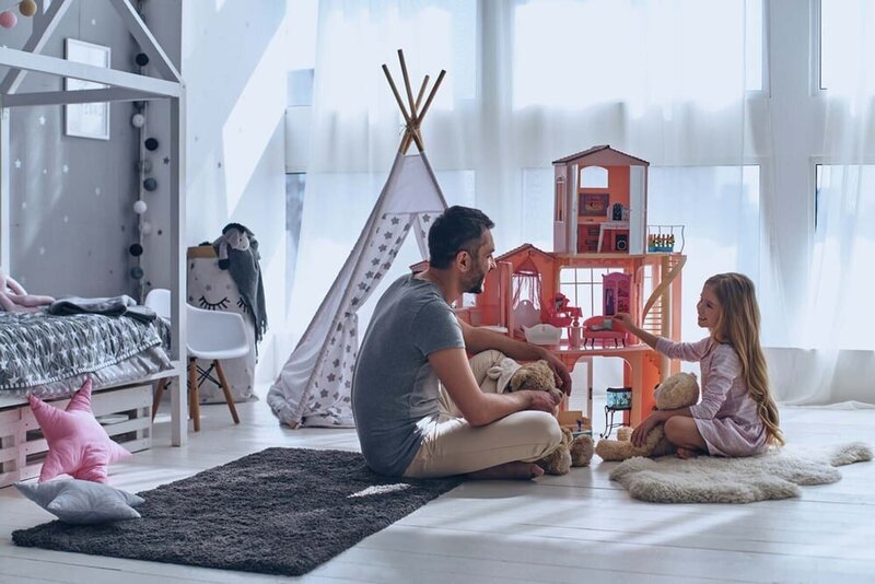 A dad and his kid enjoying playtime, illustrating the joy and connection that comes from engaged and mindful parenting.