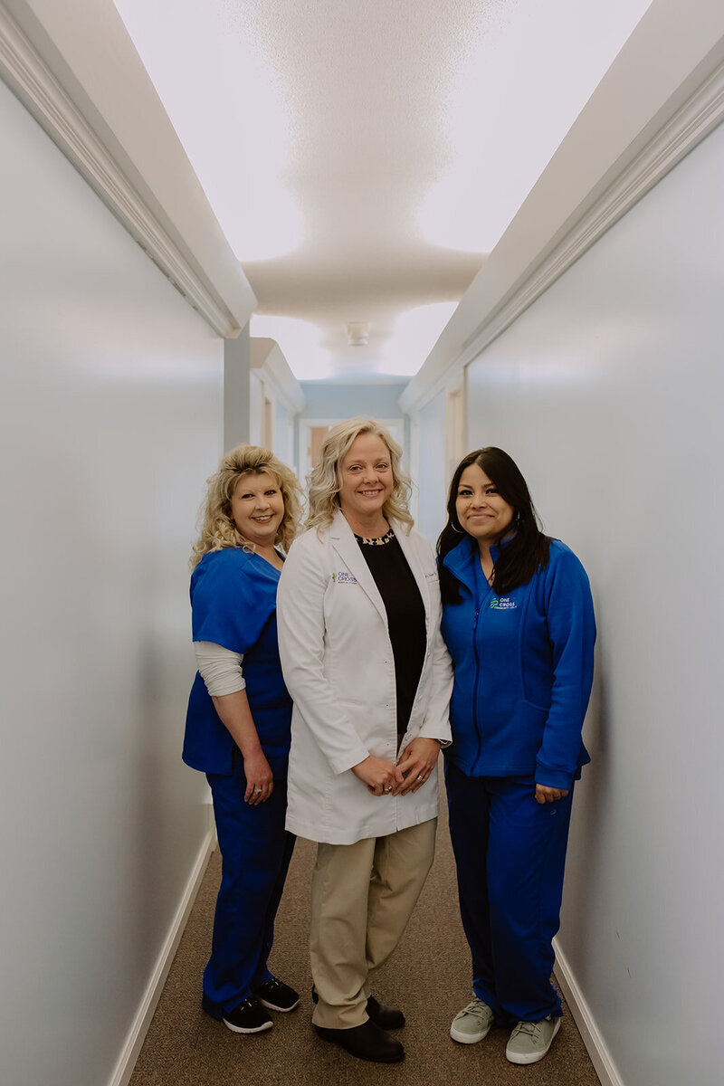 Two nurses and a doctor standing in a hallway