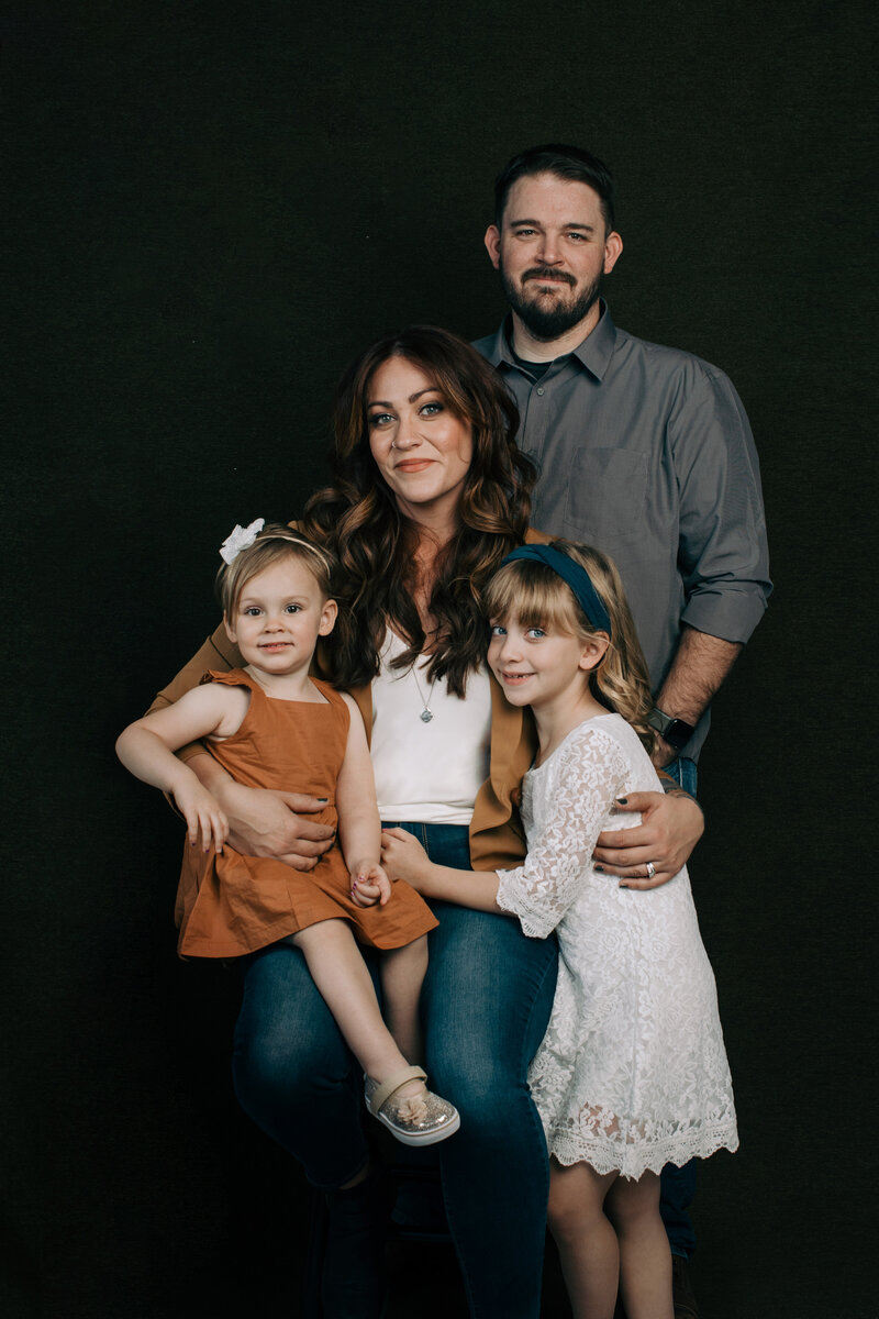 Tara, her husband, and two daughters, taken in a studio