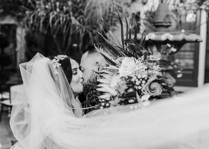 Bride and groom kissing for portraits