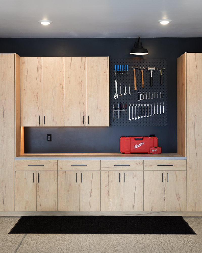Custom garage cabinets and a peg board with tools hanging up in size order