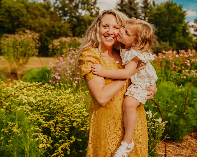 mom holding toddler edmonton flower garden at family photo shoot