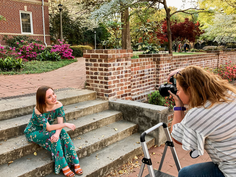 A photographer taking senior portraits on the campus of USC in Columbia SC