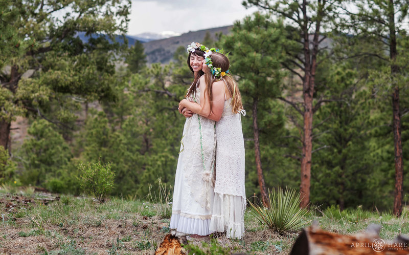 Beautiful photo of two brides snuggling on their wedding day at Bucksnort Disc Golf in Colorado