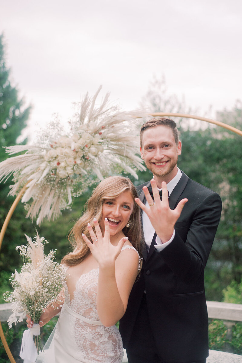 Just married couple showing off their wedding rings, featured on Bronte Bride, showcasing beautiful wedding inspiration, real local couples, and amazing Canadian Wedding Vendors.