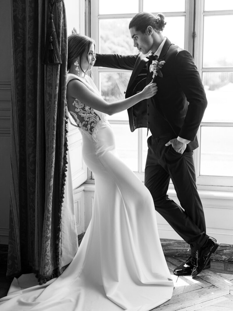 Bride touching groom's blazer