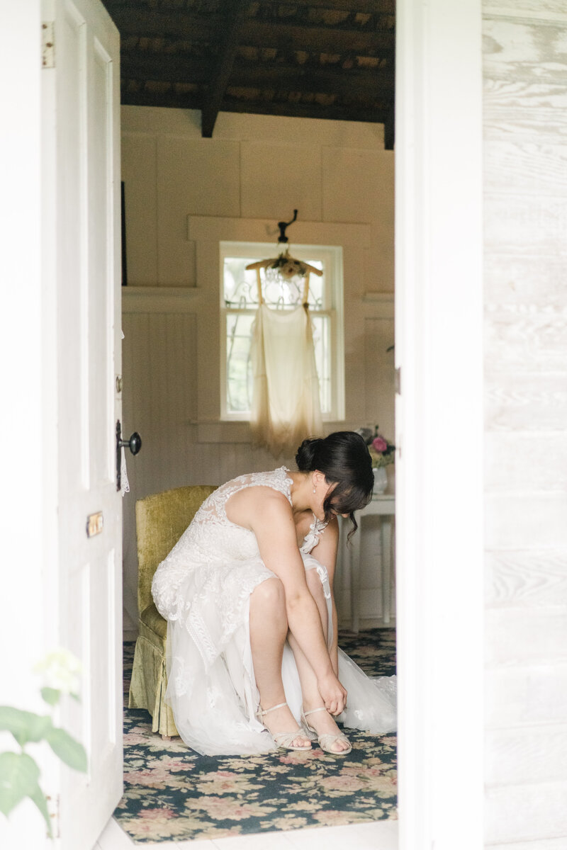bride sitting down putting on her shoes