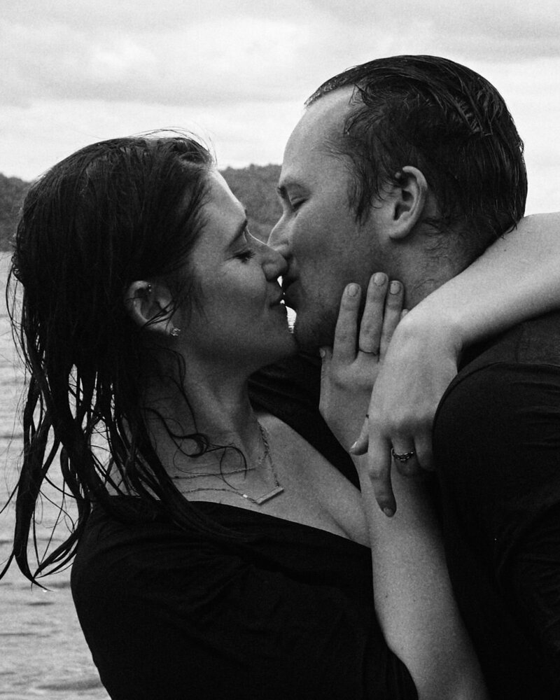 Couple shares an intimate kiss in the rain