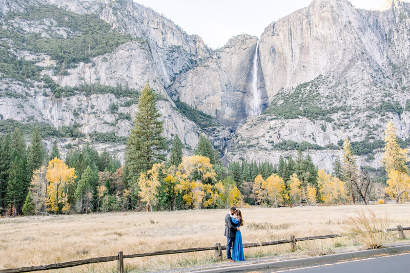 An engaged couple hodls each other close during their fall engagement photos in Yosemite