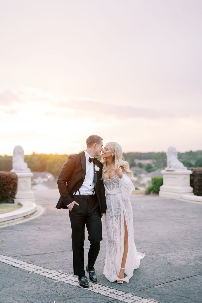 bride and groom embracing in the courtyard of a mansion