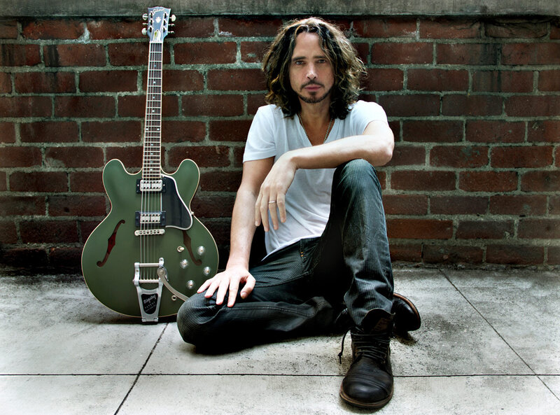 Chris Cornell Branding portrait sitting against brick wall green Signature ES 335 Gibson Guitar leaning against wall beside him