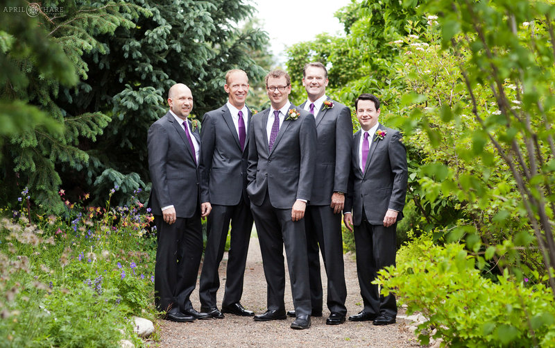 Groom poses for pictures with his groomsmen at Yampa River Botanic Park in Steamboat Springs