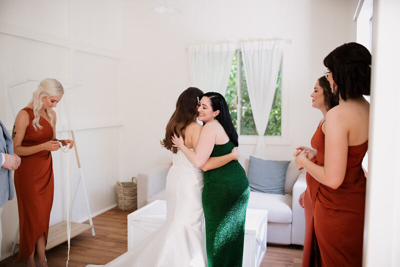 Bride and mom hugging each other