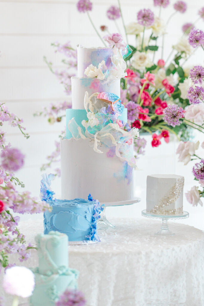 colorful cake photo with elaborate floral set up all around it at Westwind Hills