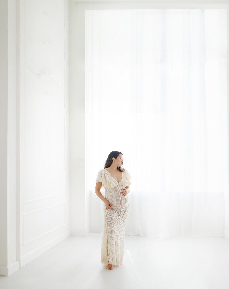 Pregnant woman poses for maternity portraits