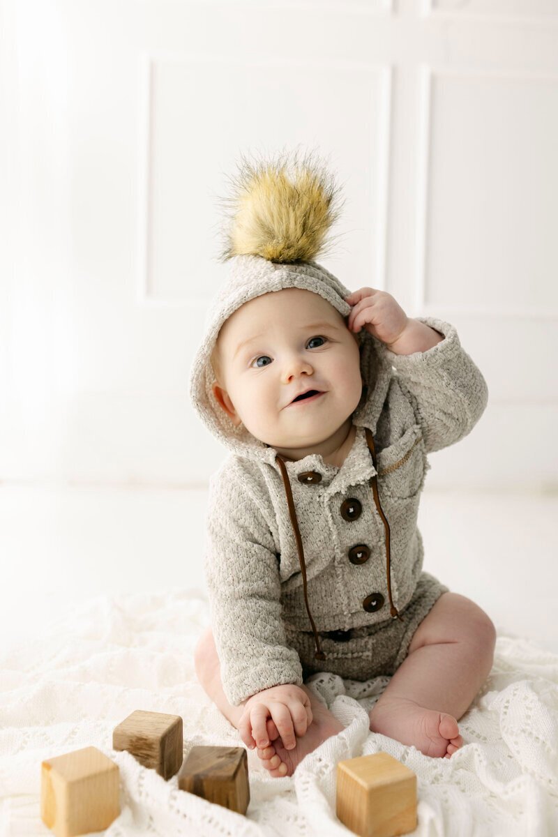 Baby wearing sweater and hat by nj cake smash photographer