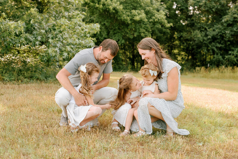 Family laughing during their Raleigh family portrait session by photographers in Raleigh A.J. Dunlap Photography