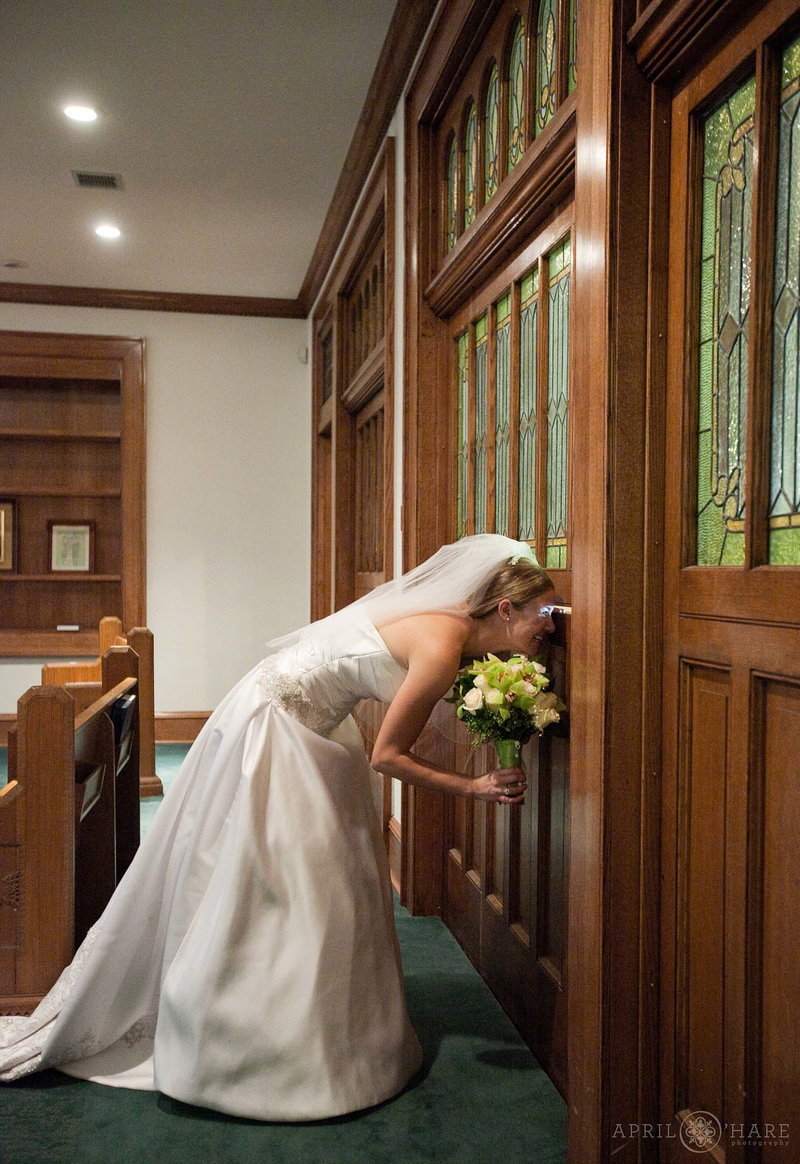 Bride looks out of the historic doorway at Central Presbyterian Church