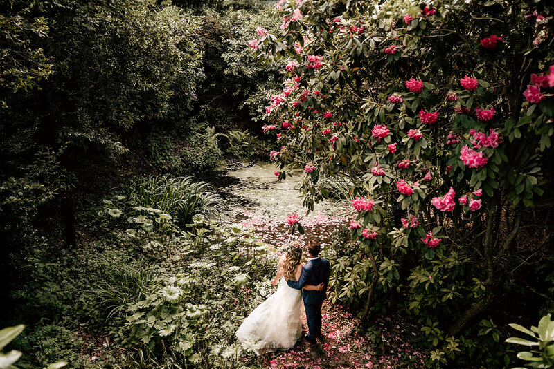 Bride and Groom standing in lush garden