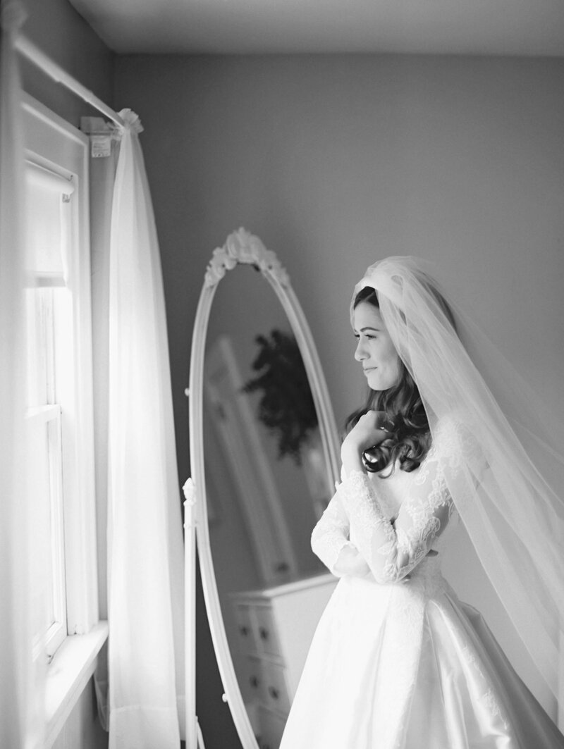 Bride looking out window photographed by Chicago editorial wedding photographer Arielle Peters