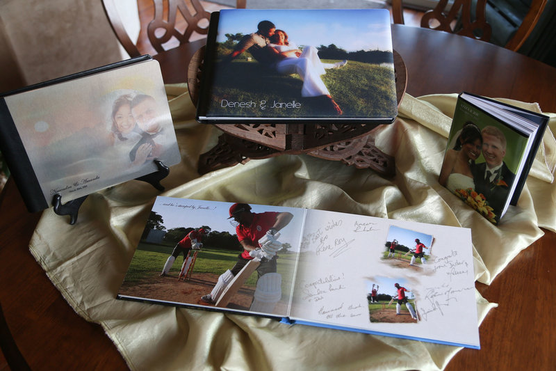 Selection of albums on tabletop. By Ross Photography, Trinidad, W.I..